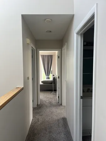 a view of a livingroom and a hallway