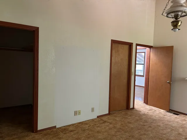 a view of walk in closet with empty racks