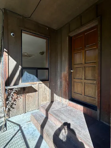 a bedroom with a bed and a wooden floor