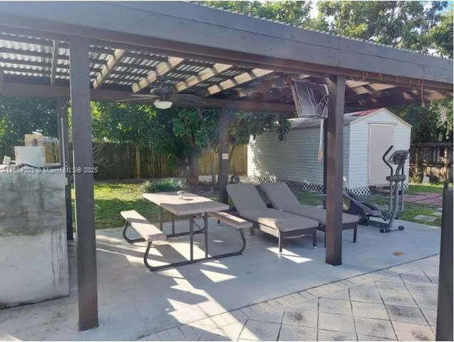 a patio with glass top table and chairs