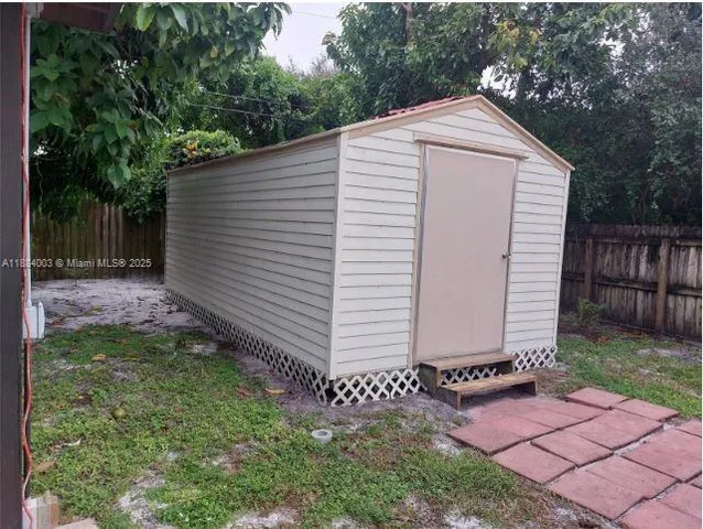 a view of a backyard with a small cabin