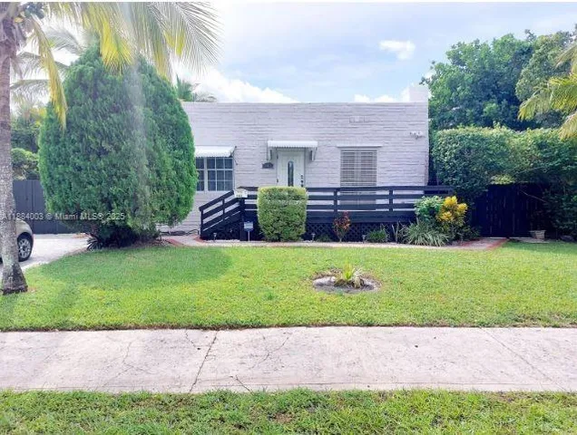a view of a bedroom with furniture and a window