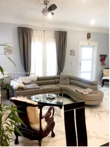 a living room with furniture and a window