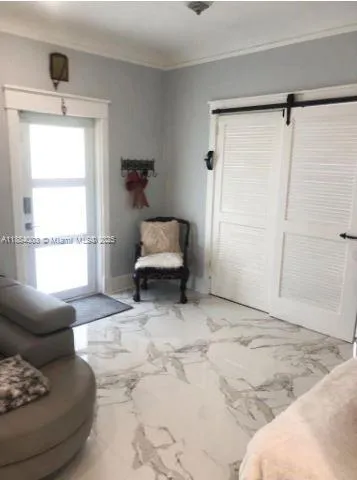 a view of a dining room with furniture and a window