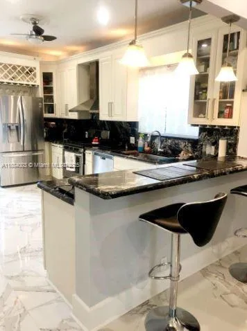 a kitchen with a stove and a chandelier