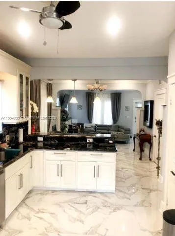 a living room with furniture and a bookshelf