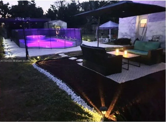 a view of a backyard with sitting area