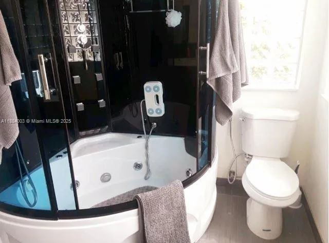 a patio with a table and chairs and potted plants