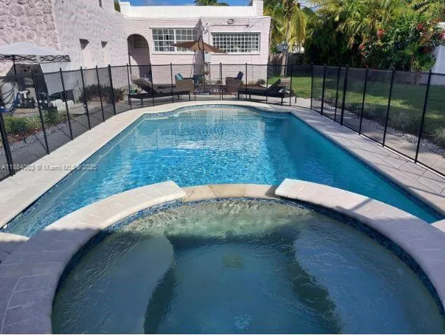 a view of a swimming pool with a patio