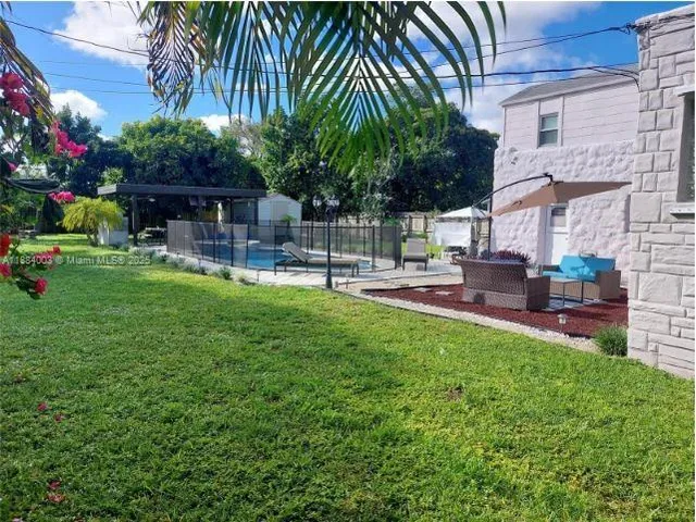 a house view with a sitting space and garden
