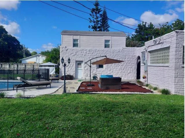 a view of a house with a yard and patio