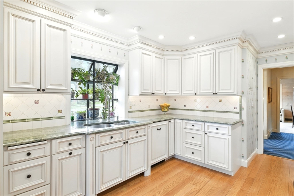 68 Normandy Road Longmeadow, MA 01106 - Photo 15 of 42 a kitchen with granite countertop white cabinets white appliances and sink