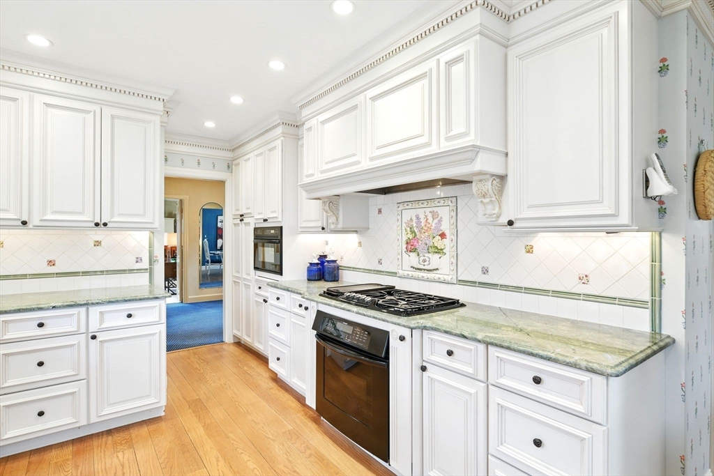 68 Normandy Road Longmeadow, MA 01106 - Photo 16 of 42 a kitchen with granite countertop white cabinets and stainless steel appliances