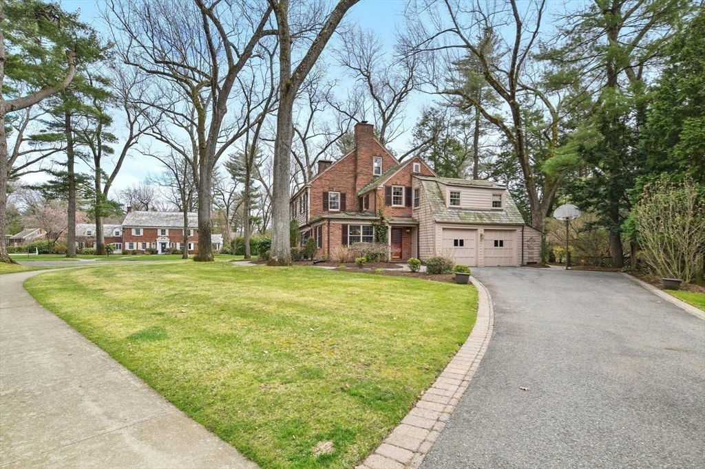 68 Normandy Road Longmeadow, MA 01106 - Photo 41 of 42 a front view of a house with a garden and trees
