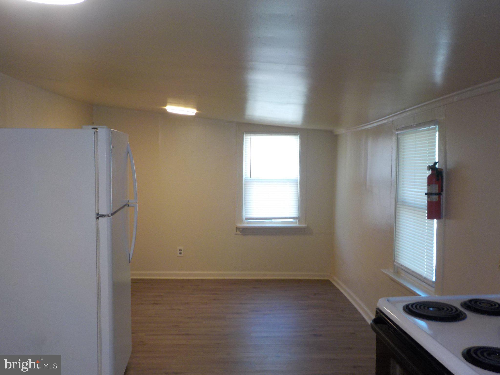 26 Walnut Street, Unit A Salem, NJ 08079 - Photo 4 of 11 a view of an empty room with wooden floor and a window