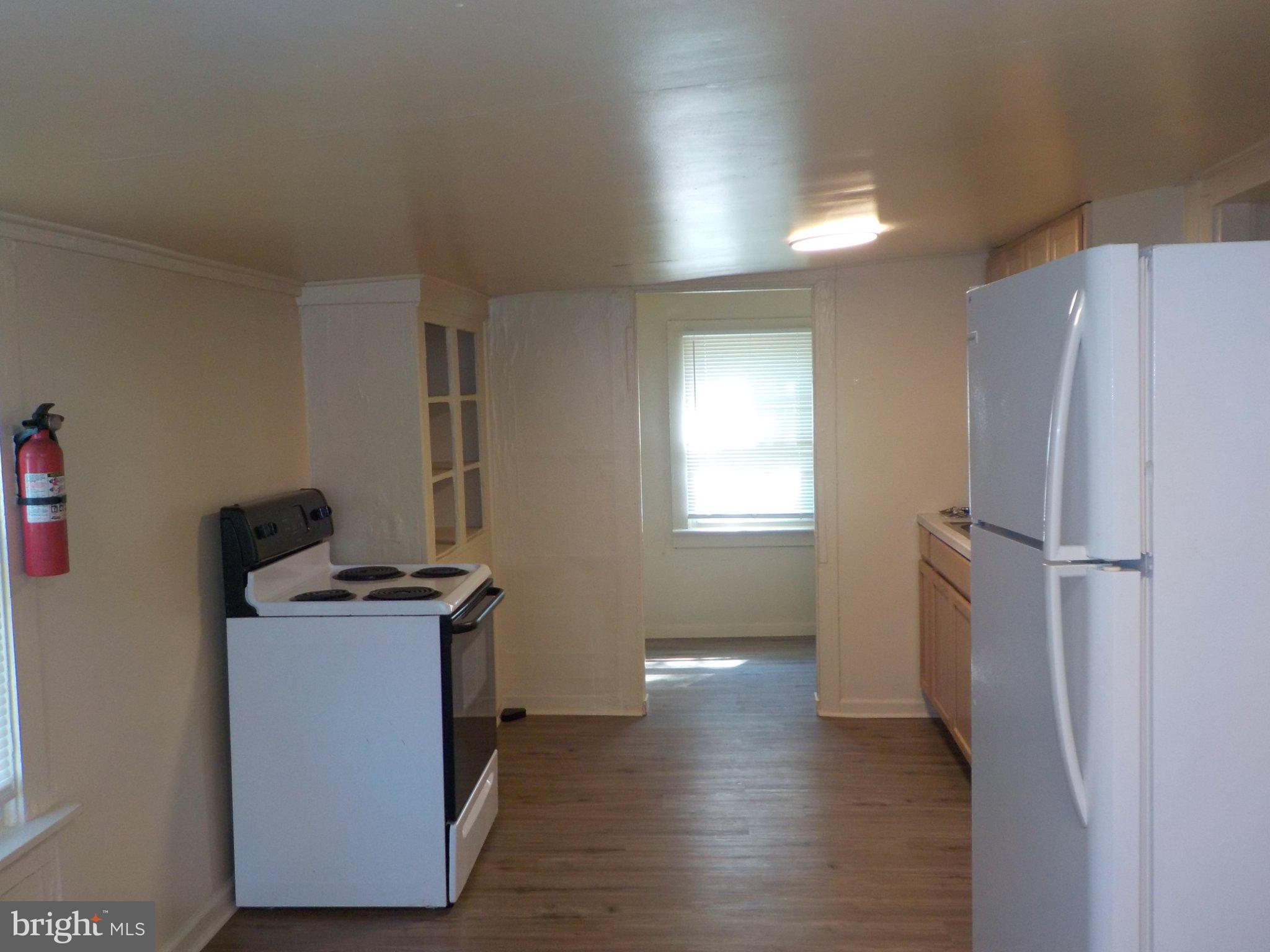 26 Walnut Street, Unit A Salem, NJ 08079 - Photo 5 of 11 a view of a kitchen with a sink refrigerator and window