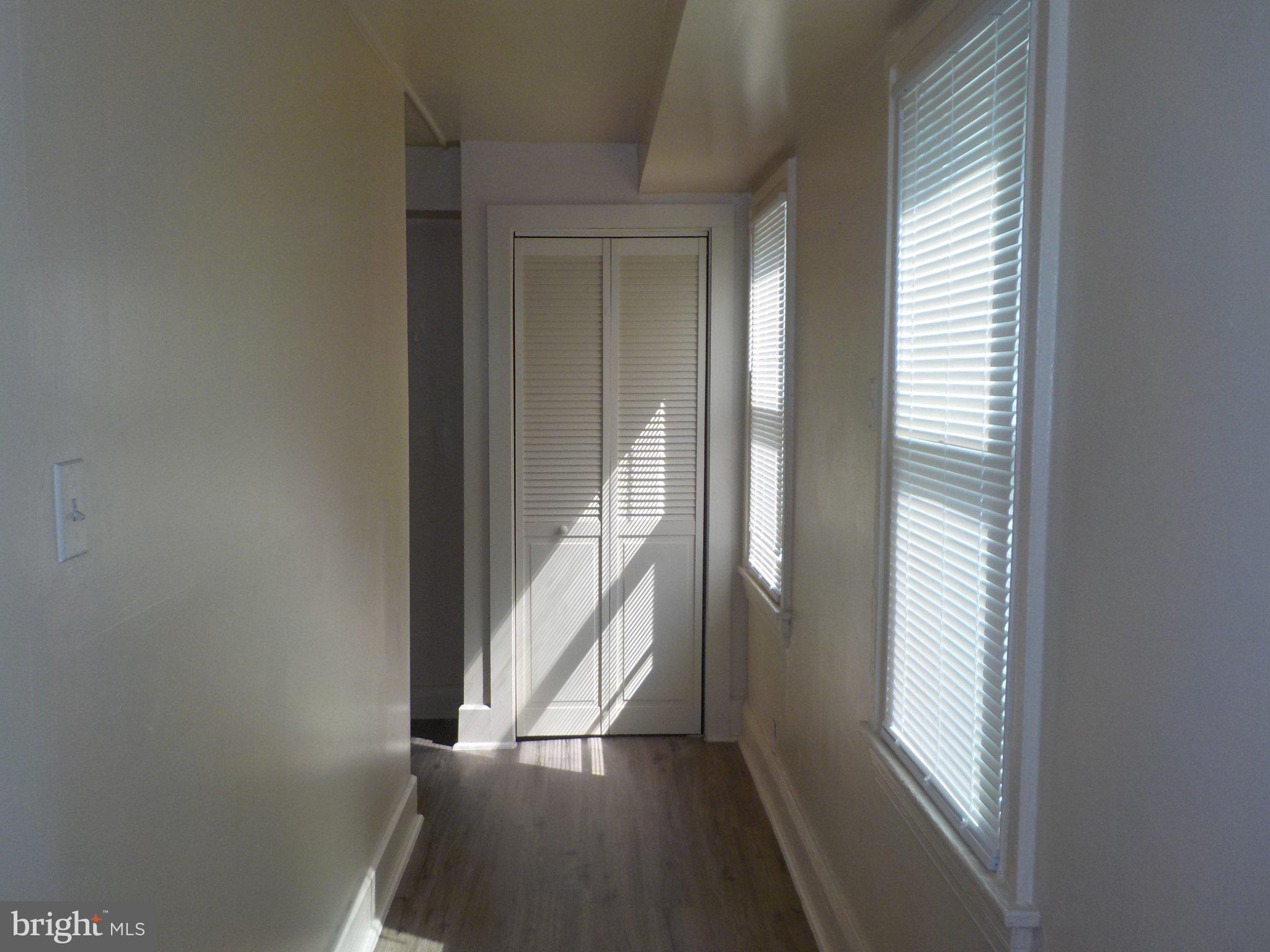 26 Walnut Street, Unit A Salem, NJ 08079 - Photo 9 of 11 a view of a hallway with wooden floor and stairs