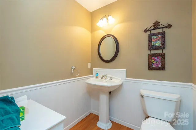a bathroom with a toilet sink and a mirror