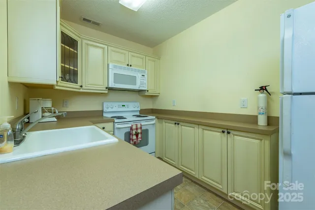 a room with a sink cabinets and wooden floor