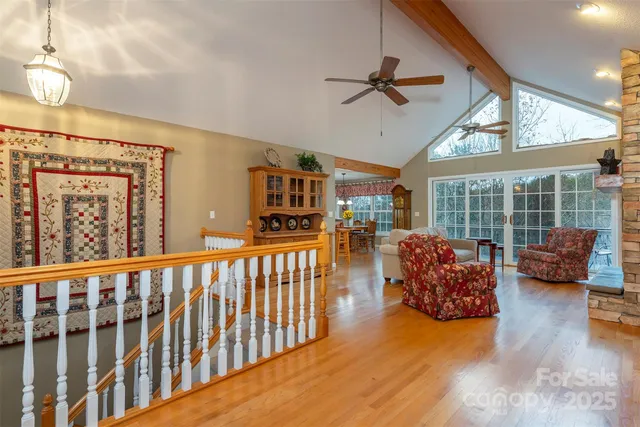 a view of a livingroom with furniture wooden floor and windows