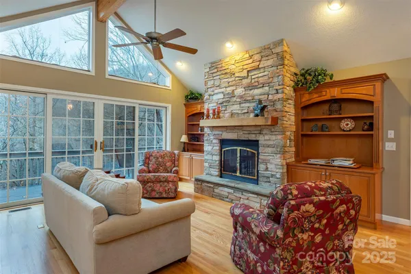 a living room with furniture a window and a fireplace
