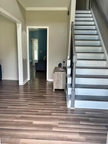 a view of entryway and hall with wooden floor