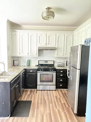 a kitchen with a stove a sink and a refrigerator