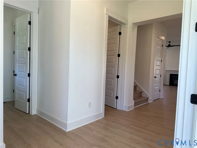 an empty room with windows and closet