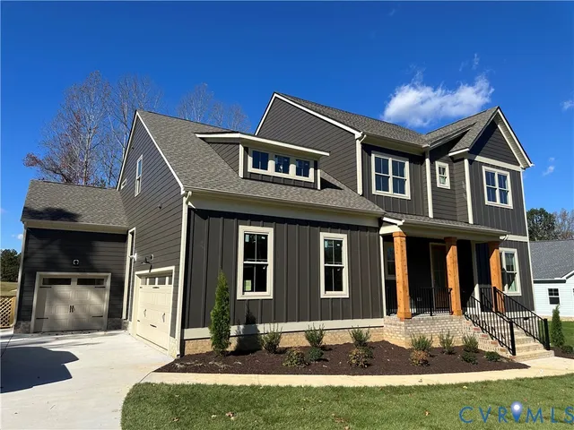 a front view of a house with yard and parking