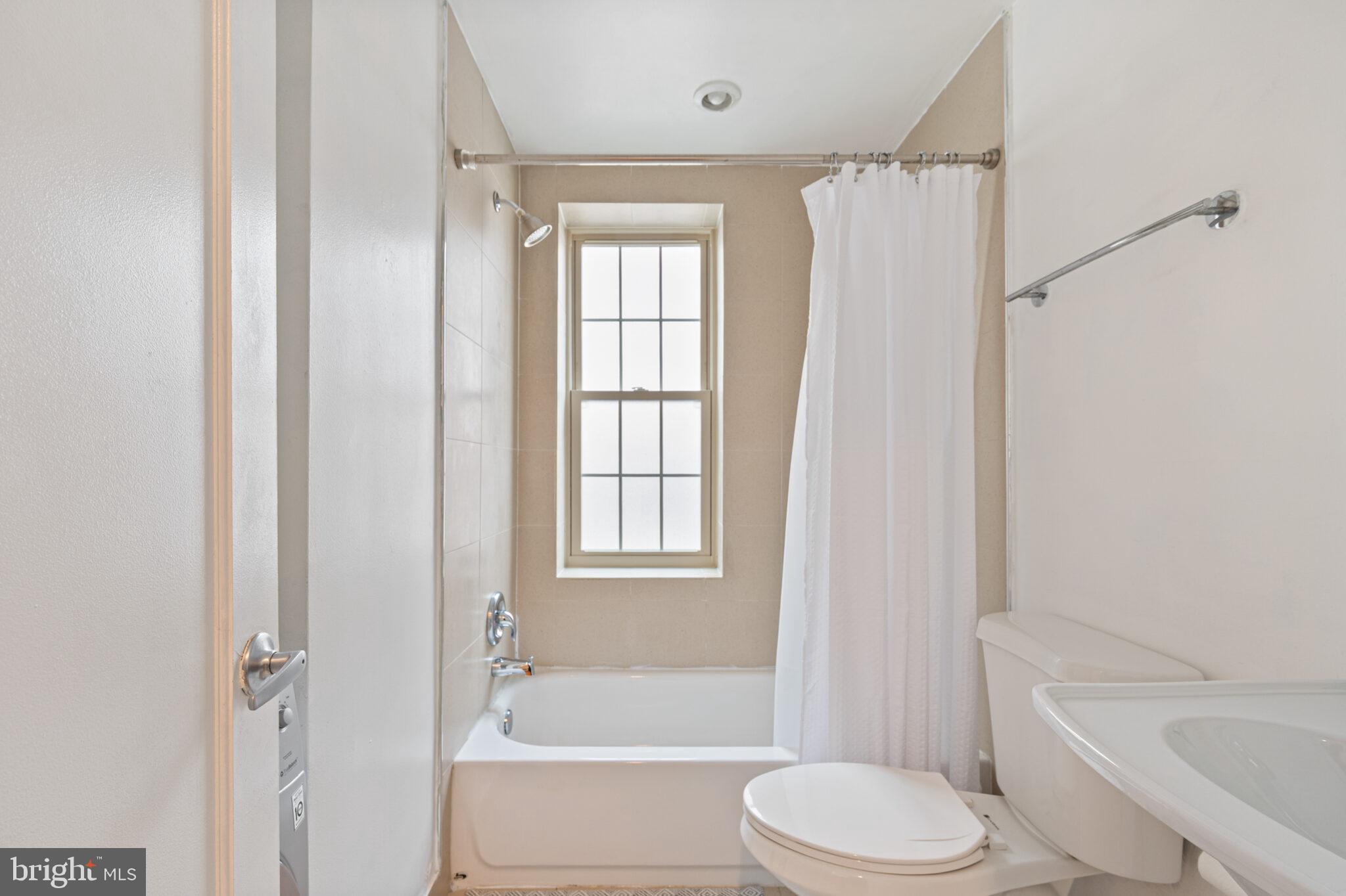 1314 Massachusetts Avenue Northwest, Unit 608 Washington, DC 20005 - Photo 19 of 40 a bathroom with a toilet bathtub window and shower