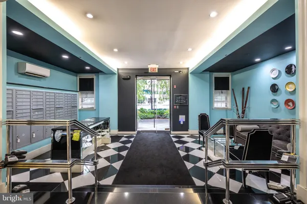 a room with a black white checkered floor with a rug