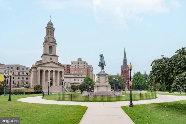 a view of a tall building next to a road