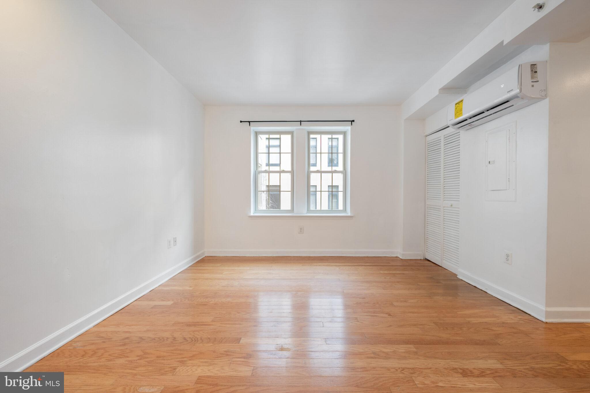 1314 Massachusetts Avenue Northwest, Unit 608 Washington, DC 20005 - Photo 7 of 40 an empty room with wooden floor and windows