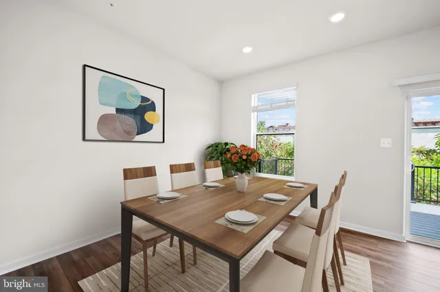 a view of a dining room with furniture window and wooden floor