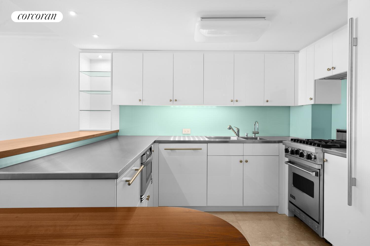 27 East 65th Street, Unit 14CD Manhattan, NY 10065 - Photo 14 of 16 a kitchen with a sink cabinets and stainless steel appliances