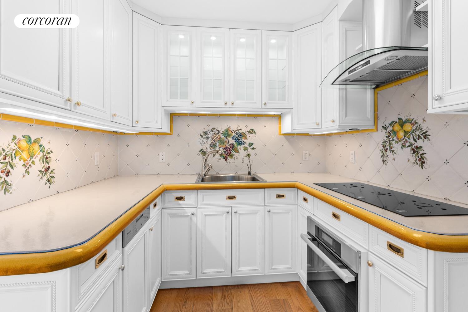 27 East 65th Street, Unit 14CD Manhattan, NY 10065 - Photo 3 of 16 a kitchen with stainless steel appliances granite countertop a sink a stove and cabinets