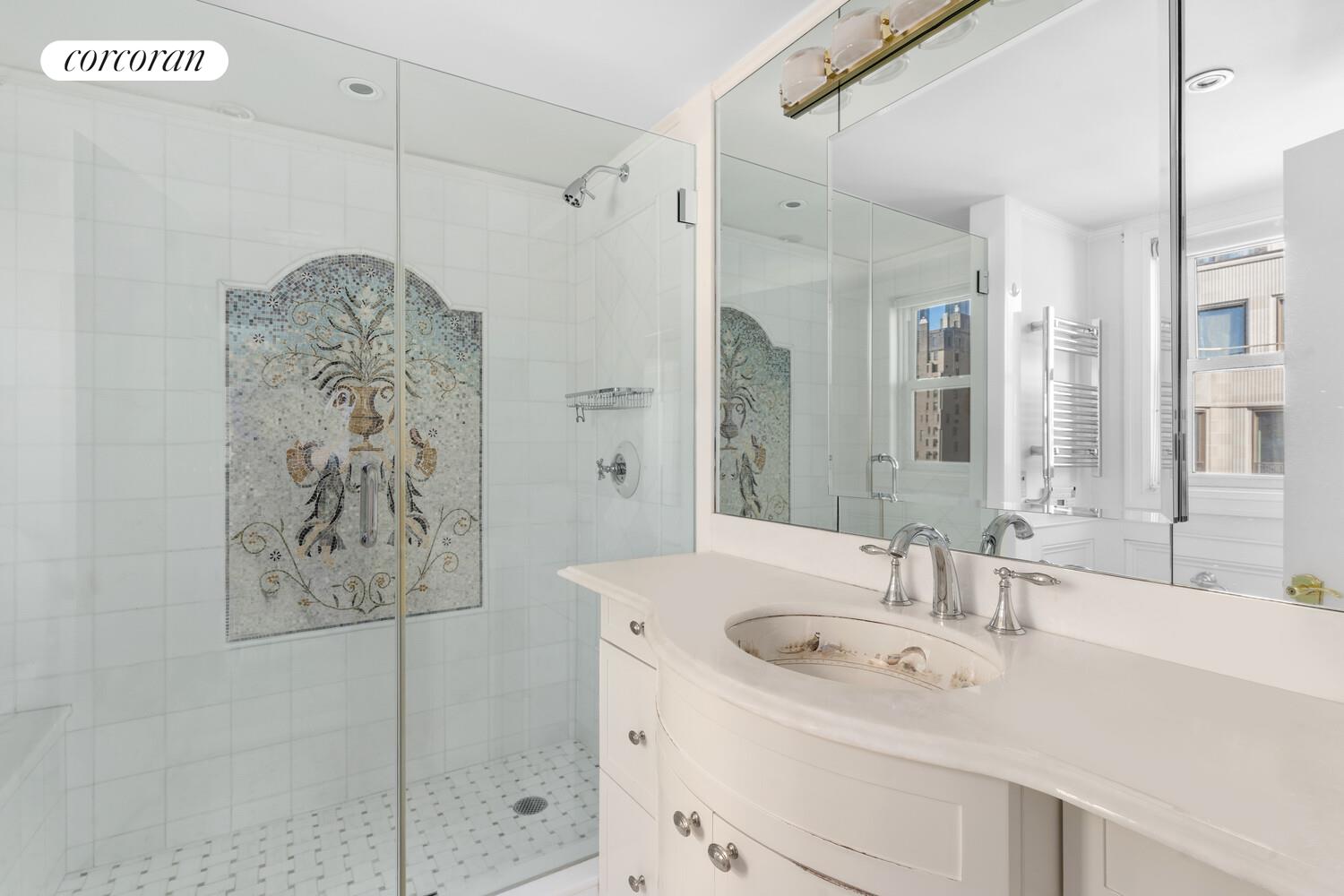 27 East 65th Street, Unit 14CD Manhattan, NY 10065 - Photo 6 of 16 a bathroom with a sink and a mirror