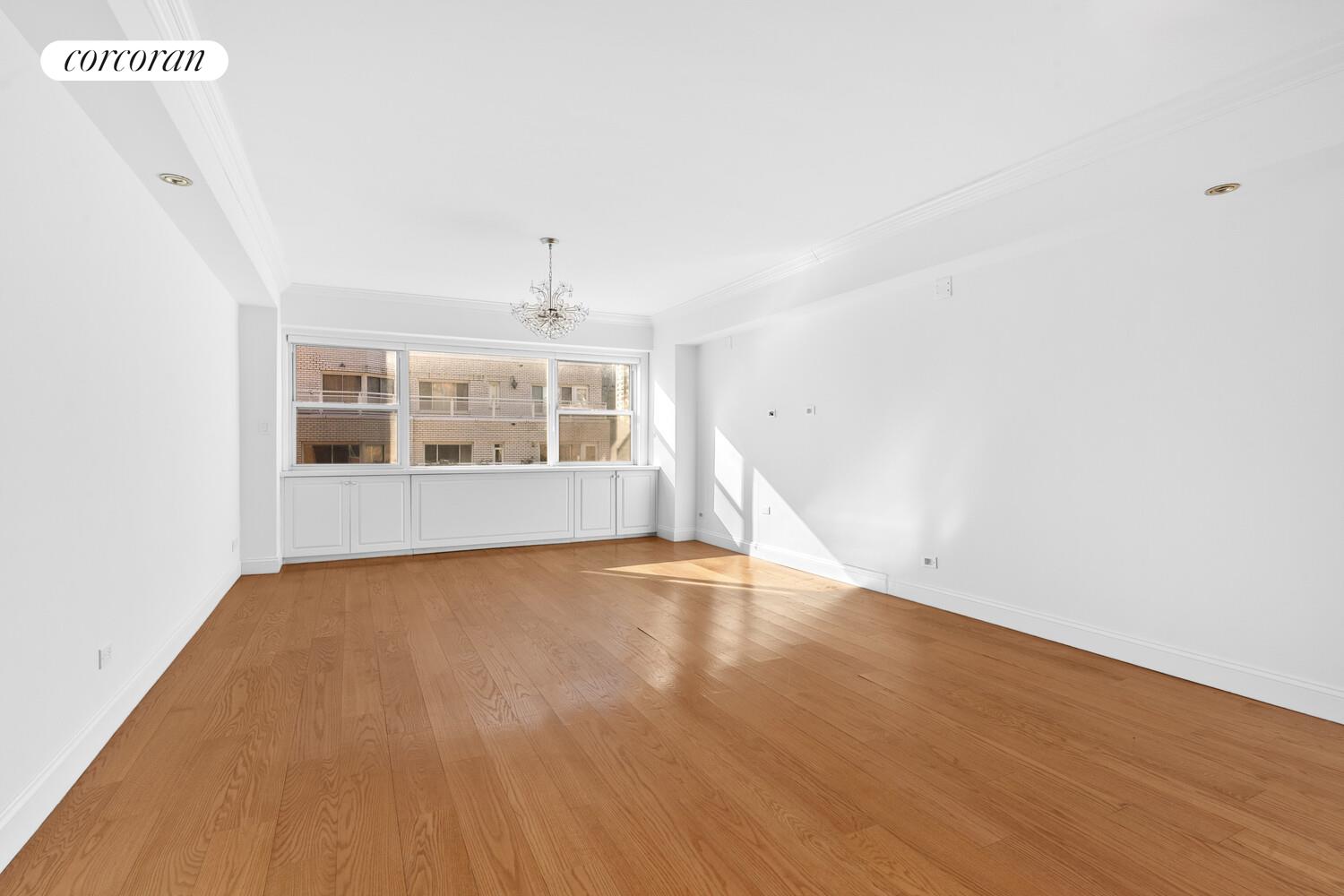 27 East 65th Street, Unit 14CD Manhattan, NY 10065 - Photo 8 of 16 a view of an empty room with a window and wooden floor