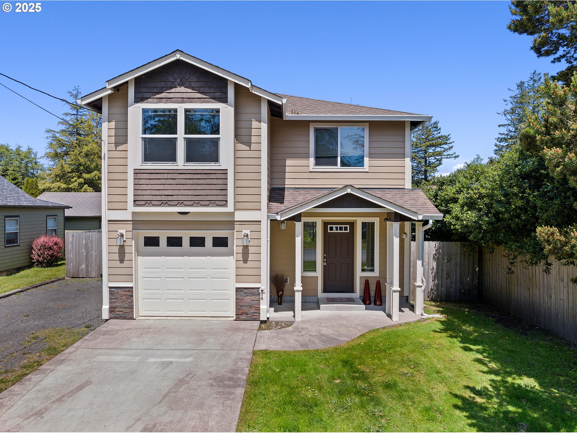 a front view of a house with a yard and garage