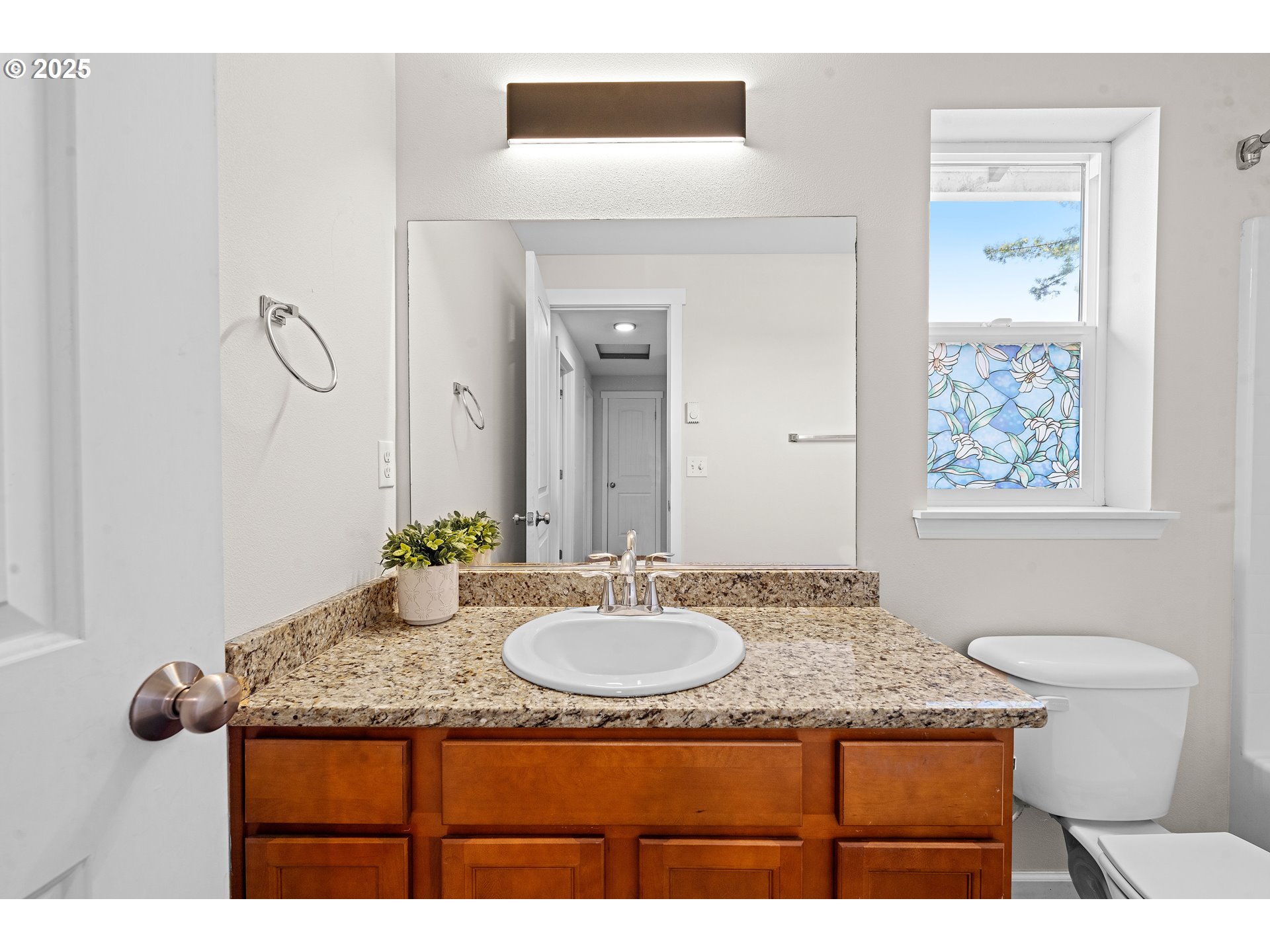 1225 3rd Avenue Hammond, OR 97121 - Photo 27 of 47 a bathroom with a granite countertop sink a toilet and mirror