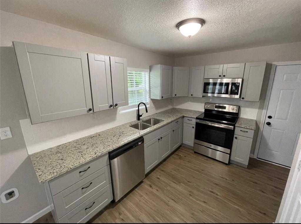 2722 Hector Street Dallas, TX 75210 - Photo 4 of 10 a kitchen with granite countertop a sink and cabinets