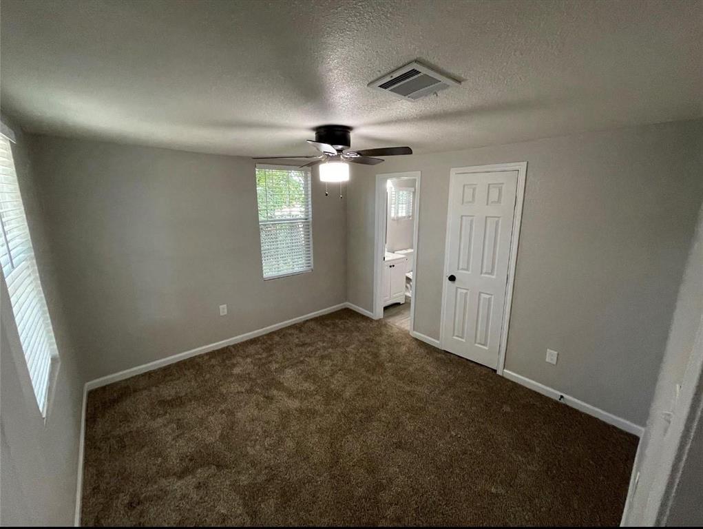 2722 Hector Street Dallas, TX 75210 - Photo 6 of 10 an empty room with windows and fan
