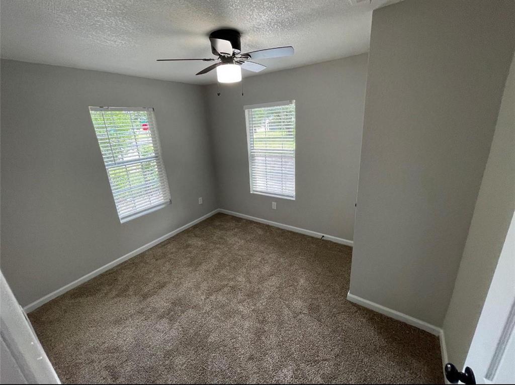 2722 Hector Street Dallas, TX 75210 - Photo 10 of 10 an empty room with windows and fan