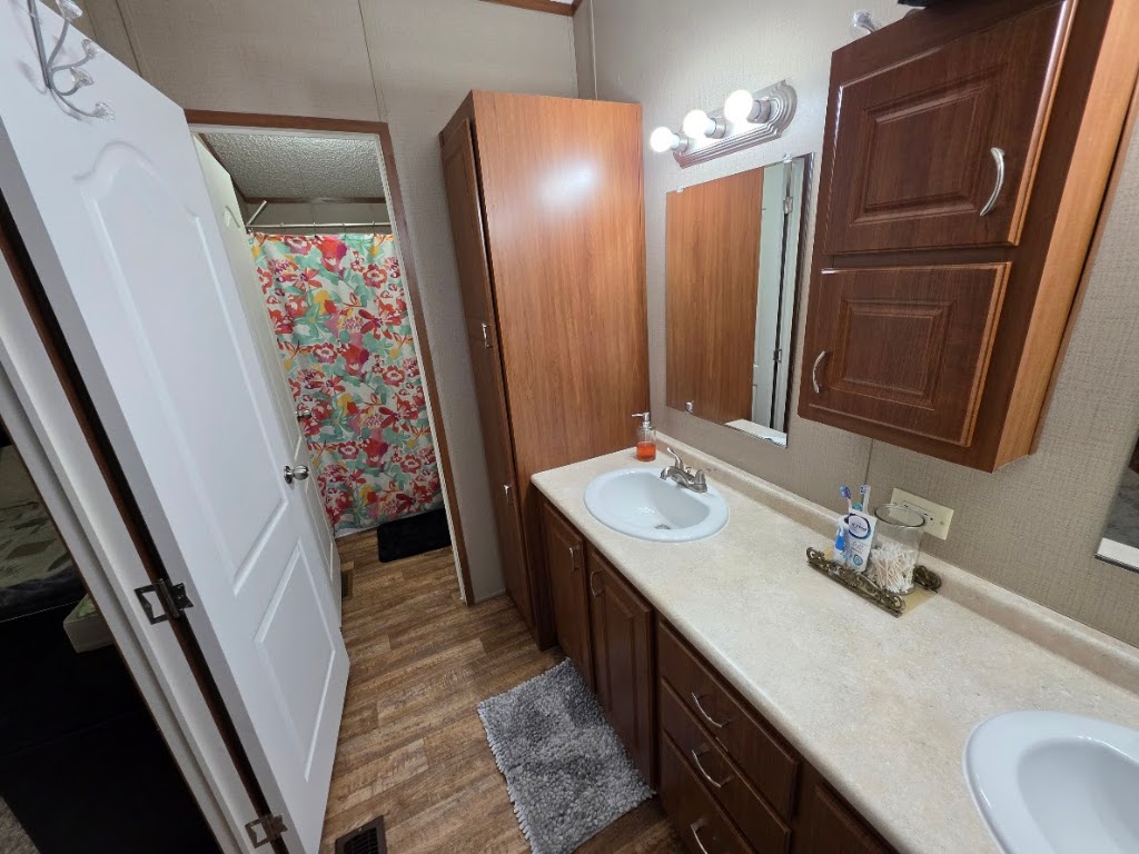 1100 Rustler Pass Kyle, TX 78640 - Photo 9 of 14 a bathroom with double vanity and a mirror