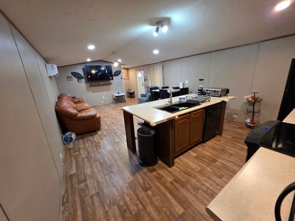 1100 Rustler Pass Kyle, TX 78640 - Photo 13 of 14 a kitchen with stainless steel appliances granite countertop a sink stove and wooden floor