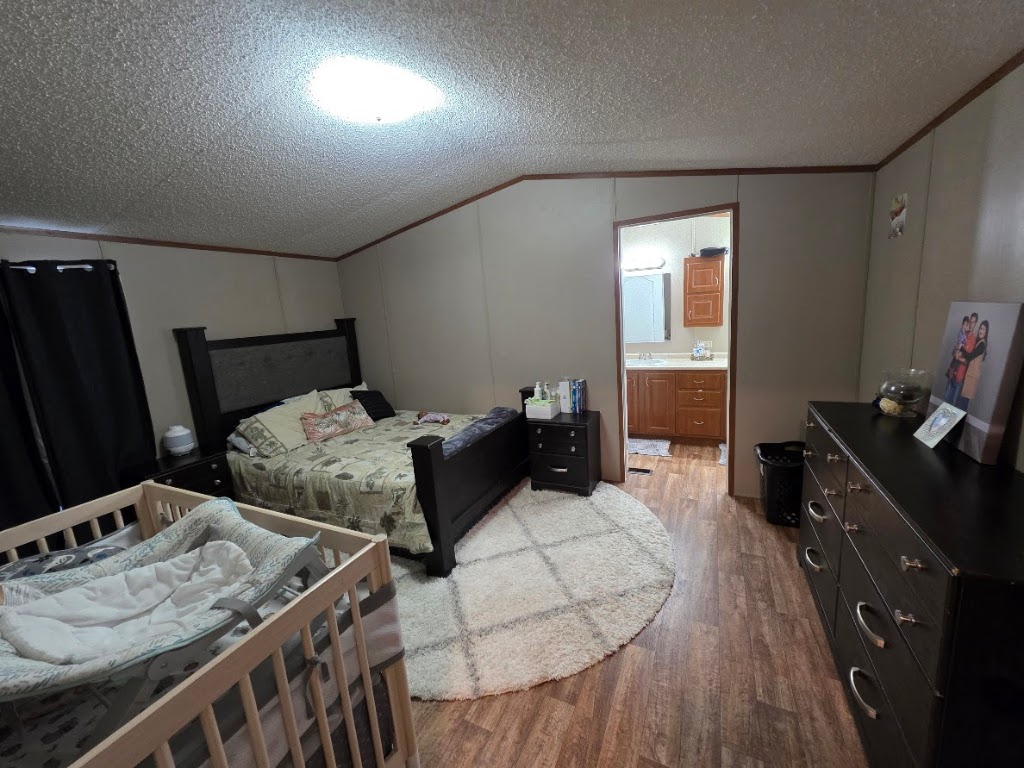 1100 Rustler Pass Kyle, TX 78640 - Photo 8 of 14 a bedroom with furniture and a wooden floor