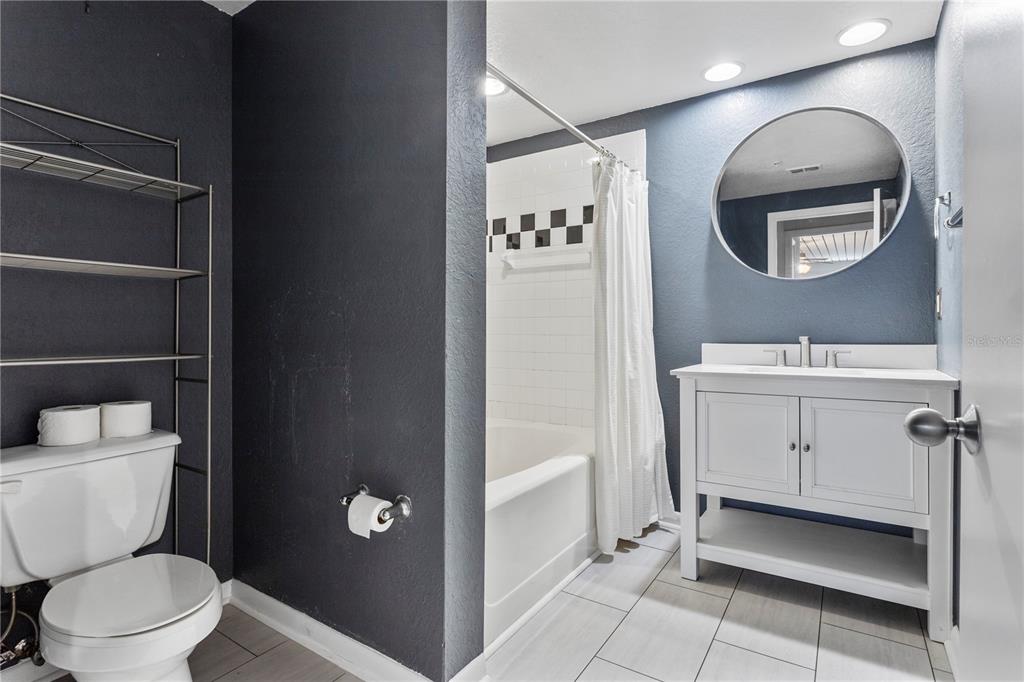 2411 West Horatio Street, Unit 522 Tampa, FL 33609 - Photo 14 of 21 a bathroom with a toilet a sink and mirror