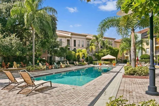 a swimming pool with outdoor seating and yard