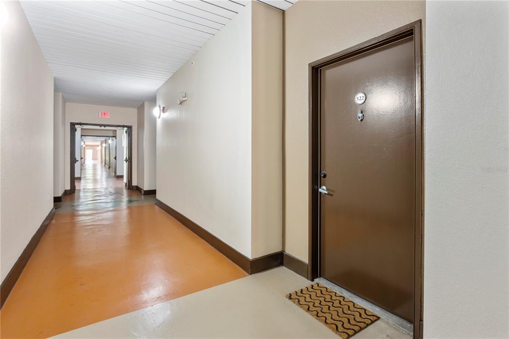 2411 West Horatio Street, Unit 522 Tampa, FL 33609 - Photo 4 of 21 a view of a hallway with wooden floor and a bathroom