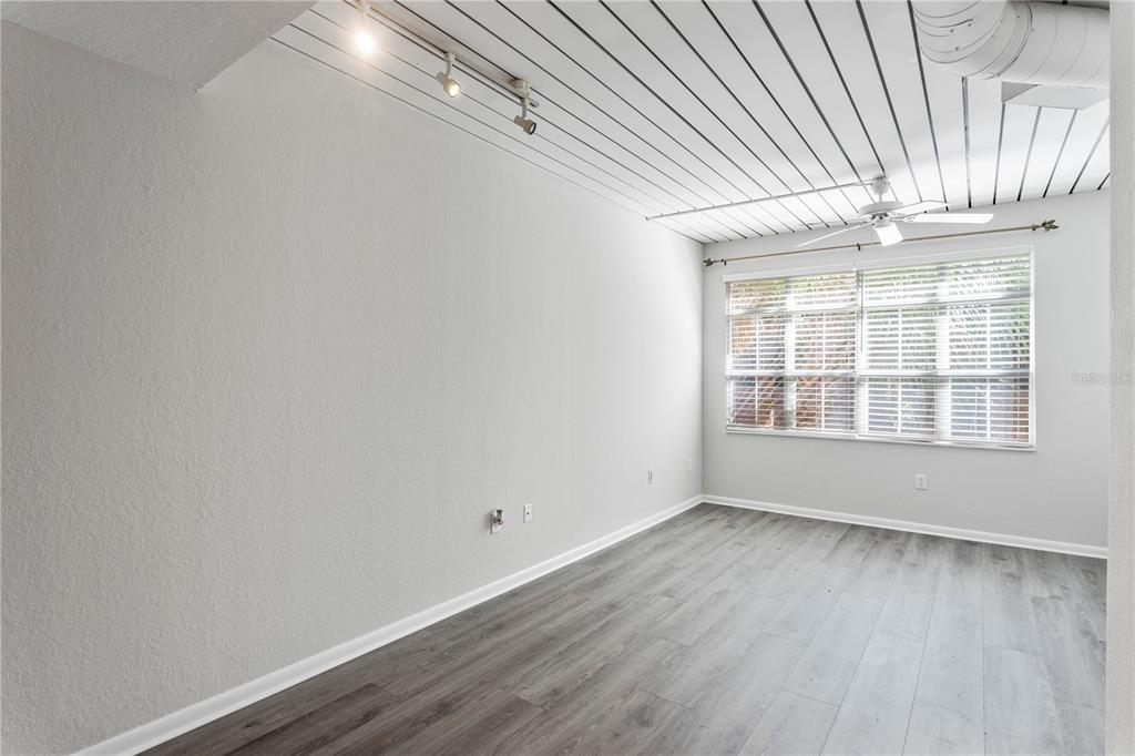 2411 West Horatio Street, Unit 522 Tampa, FL 33609 - Photo 10 of 21 a view of an empty room with wooden floor and a window